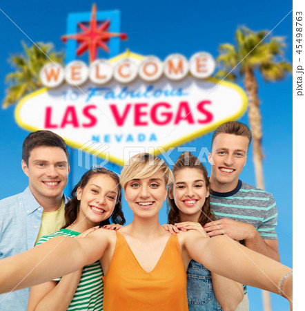 happy friends taking selfie over las vegas sign happy friends taking selfie over las vegas sign 45498763