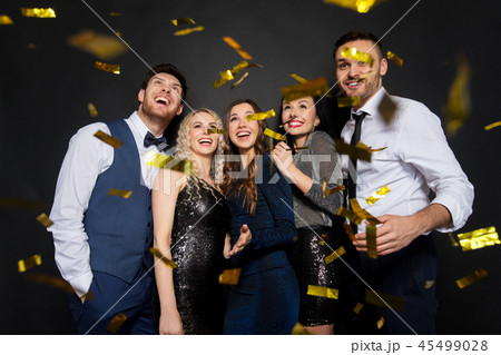 happy friends at party under confetti over black happy friends at party under confetti over black 45499028