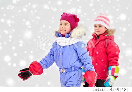 happy little girls in winter clothes outdoors 45499189