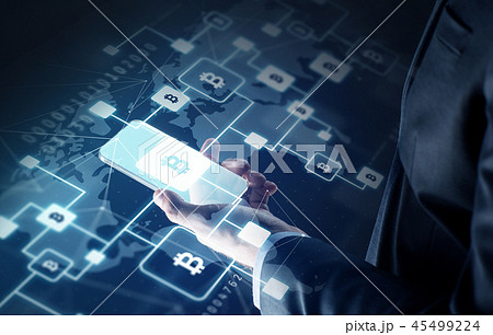 close up of hand with smartphone and bitcoin close up of hand with smartphone and bitcoin 45499224