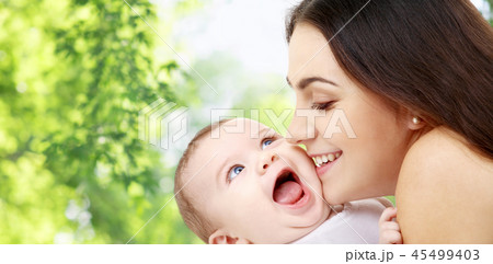 mother with baby over green natural background mother with baby over green natural background 45499403