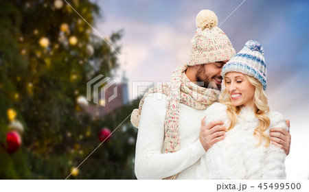 happy couple hugging over christmas tree happy couple hugging over christmas tree 45499500
