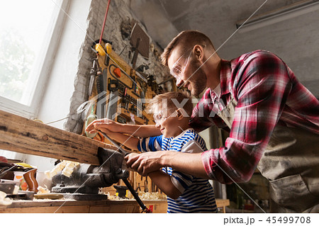 father and son with rasp working at workshop 45499708