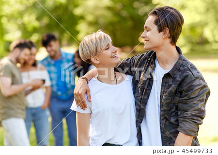 happy teenage couple hugging at summer park happy teenage couple hugging at summer park 45499733