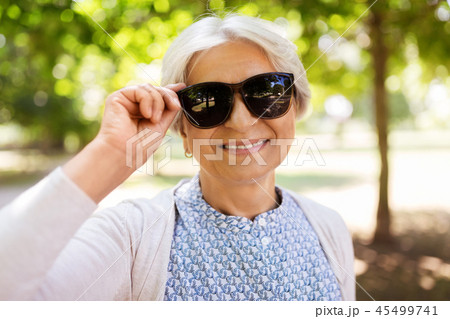 portrait of happy senior woman at summer park portrait of happy senior woman at summer park 45499741