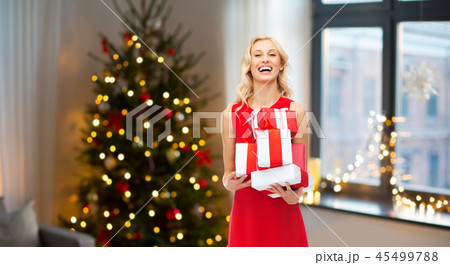 happy woman in red dress with christmas gifts 45499788