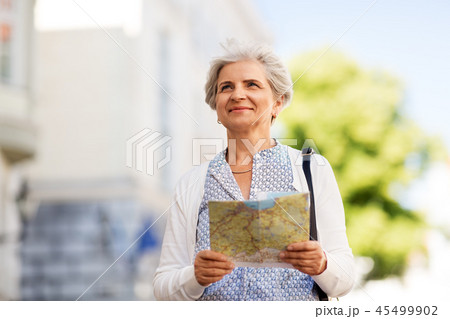 senior woman or tourist with map on city street senior woman or tourist with map on city street 45499902
