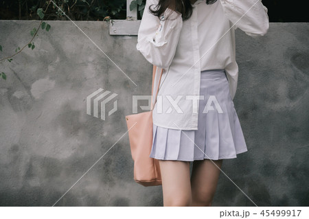 Portrait part of body young woman using telephone modern style in outdoor urban background Portrait part of body young woman using telephone modern style in outdoor urban background 45499917