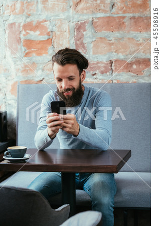 man mobile phone reading blogging idle lifestyle 45508916