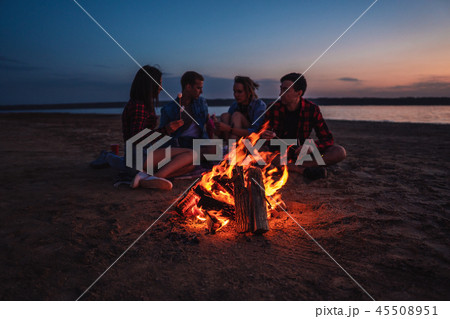 young friends have picnic with bonfire on the beach young friends have picnic with bonfire on the beach 45508951