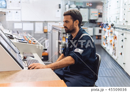 Marine engineer officer working in engine room Marine engineer officer working in engine room 45509036