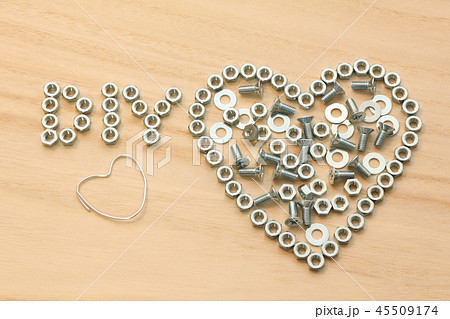 ナット等で木の板の上に描かれたハートマークと「DIY」の文字。 ナット等で木の板の上に描かれたハートマークと「DIY」の文字。 45509174