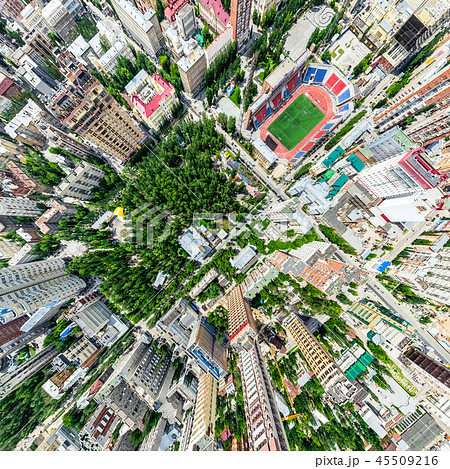 Aerial city view with crossroads and roads, houses, buildings, parks and parking lots. Sunny summer Aerial city view with crossroads and roads, houses, buildings, parks and parking lots. Sunny summer 45509216