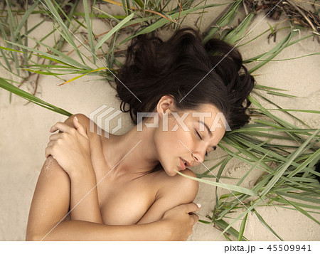 Nude beautiful woman on the nudist beach pic