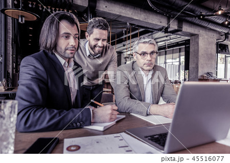Attentive mature man staring at screen of laptop Attentive mature man staring at screen of laptop 45516077