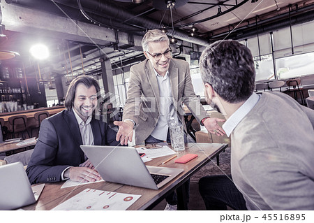 Positive delighted workers talking about modern technologies 45516895