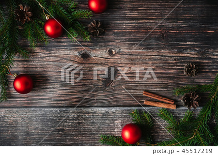 Christmas background with fir branches and red balls, pine cones. Decorative winter frame 45517219