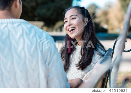 Cheerful longhaired female person listening to her partner Cheerful longhaired female person listening to her partner 45519625