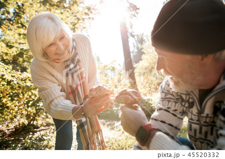 Delighted positive aged people comparing their mushrooms 45520332