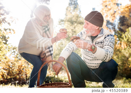 Joyful positive couple searching together for mushrooms 45520389