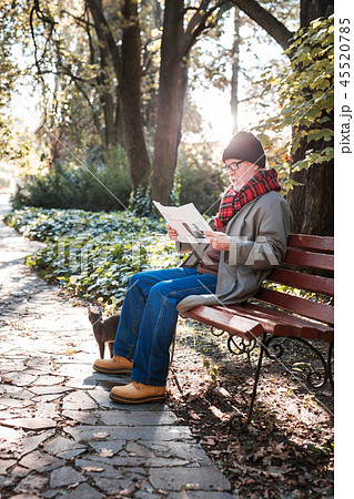 Smart aged man reading a newspaper in the park Smart aged man reading a newspaper in the park 45520785