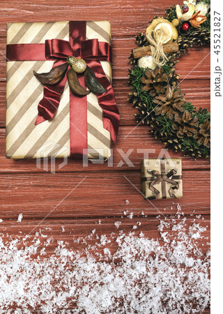 Christmas wreath and present on wooden background 45521827