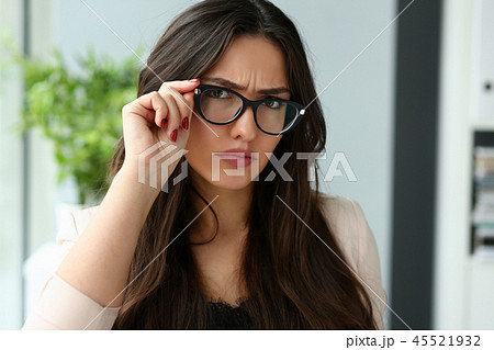 Young beautiful business woman holding glasses Young beautiful business woman holding glasses 45521932