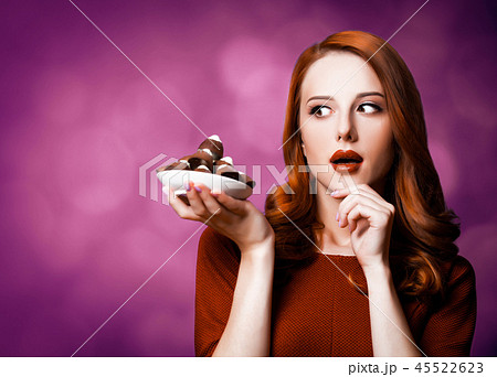 woman with candy on violet background. woman with candy on violet background. 45522623