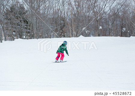 スノーボードのターン 小学生の女の子 の写真素材