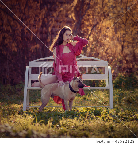 Portrait of a girl in a dress on an autumn backgro 45532128