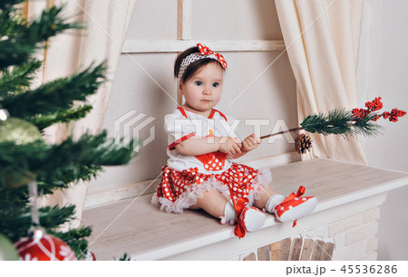 girl through the branches of a Christmas tree 45536286