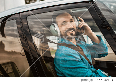 Portrait of smiling man sitting in the helicopter cabin 45536413