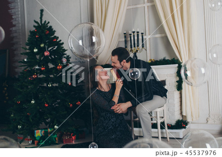 man and girl reading a book by the Christmas tree man and girl reading a book by the Christmas tree 45537976