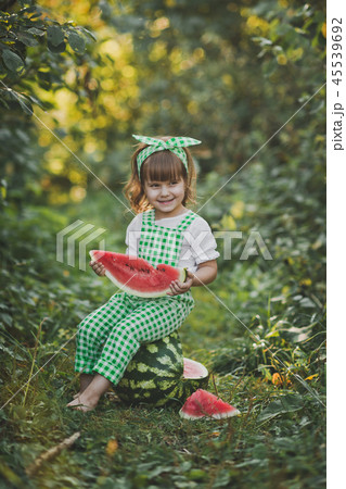Smiling child with a piece of juicy watermelon 45539692