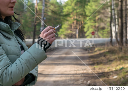cigarette in the hand of a smoking girl cigarette in the hand of a smoking girl 45540290