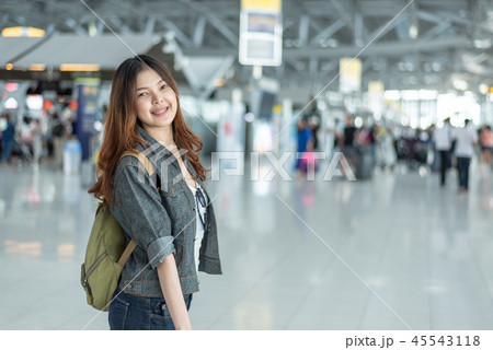Happy beauty Asian woman traveling and holding suitcase in airpo Happy beauty Asian woman traveling and holding suitcase in airpo 45543118