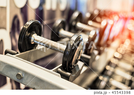 Close up of black metallic steel dumbbell set Close up of black metallic steel dumbbell set 45543398