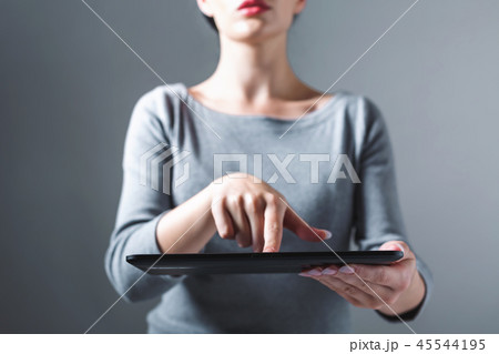Young woman using her tablet Young woman using her tablet 45544195