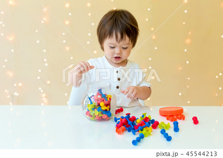Happy toddler boy playing with his toys Happy toddler boy playing with his toys 45544213