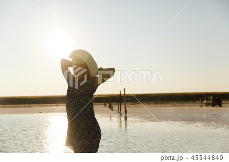 happy smiling girl in white hat enjoying sun, expanse of Bascunchak salt lake happy smiling girl in white hat enjoying sun, expanse of Bascunchak salt lake 45544849