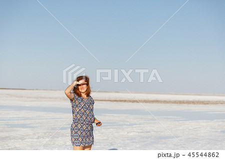 happy smiling girl enjoying sun, dancing and laughs, holds hand at his forehead 45544862