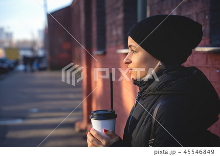 Cheerful woman in the street drinking morning coffee at winter time 45546849