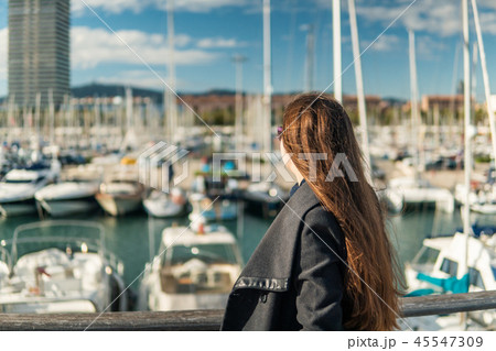 Businesswoman in sunglasses walking with a lot of yachts 45547309