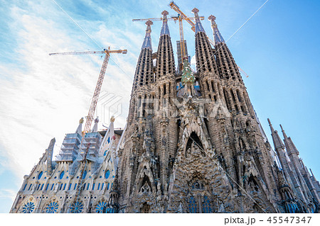 Frontal view of Sagrada Familia. cranes are still working 45547347