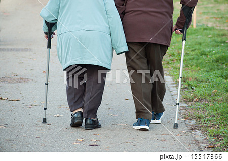 aged people walking with stick in the street aged people walking with stick in the street 45547366