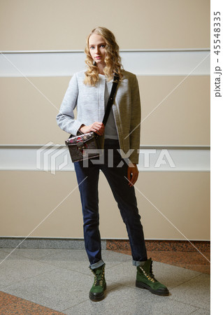 Cute student girl in jacket, jeans and boots 45548335