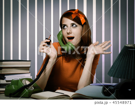 secretary near the typewriter and dial phone 45548971
