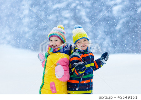 Kids playing in snow. Children play in winter. Kids playing in snow. Children play in winter. 45549151