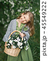 The child enjoys the spring and a basket of flower 45549222