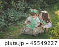 Children laugh and indulge in the street sitting 45549227